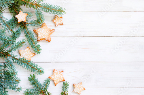 Natural white wooden background with spruce brunches and cookies photo