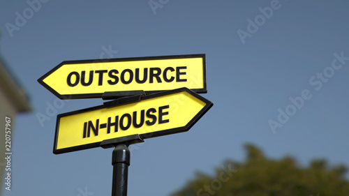 A road sign with outsource inhouse words. 3d image.