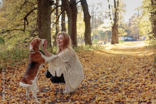 Wallpaper Mural Young beautiful girl playing with a dog in the park. Torontodigital.ca