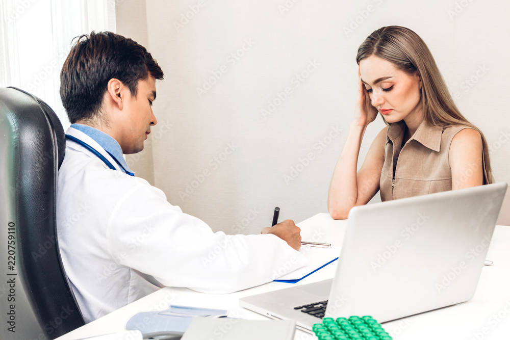 Fototapeta premium Doctor discussing and consulting with female patien on doctors table in hospital.healthcare and medicine