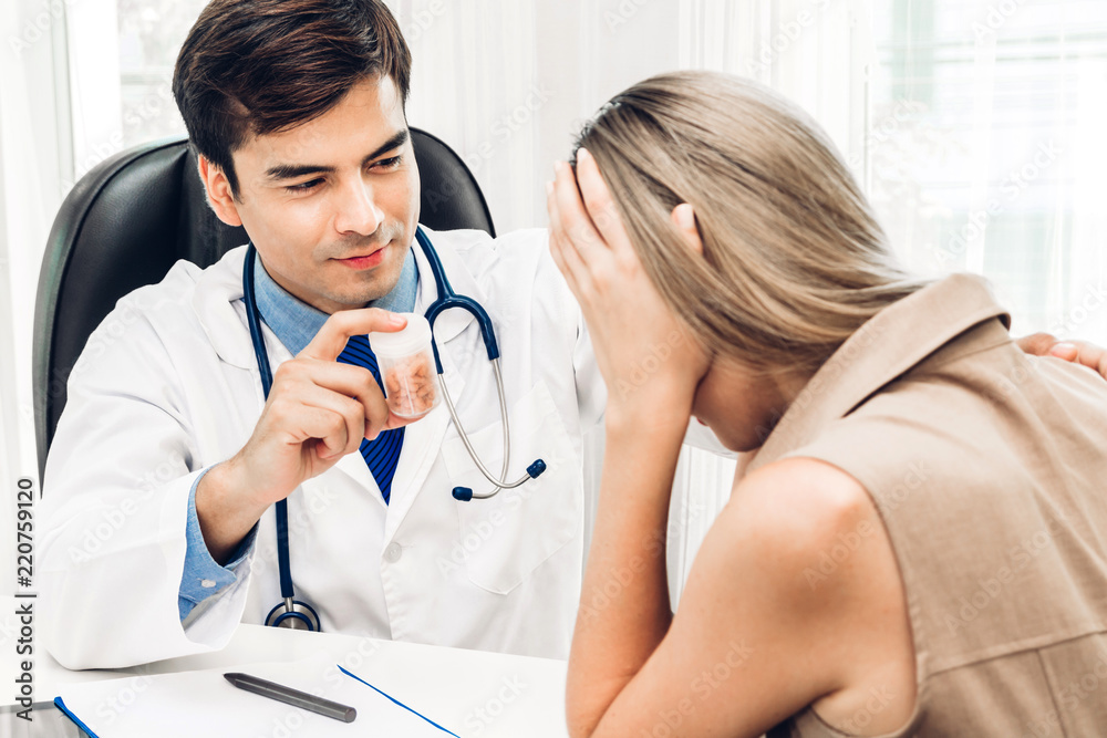 Doctor holding pill with patient in hospital.healthcare and medicine Doctor holding pill with patient in hospital.healthcare and medicine