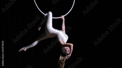 Woman acrobat making trick in circle
