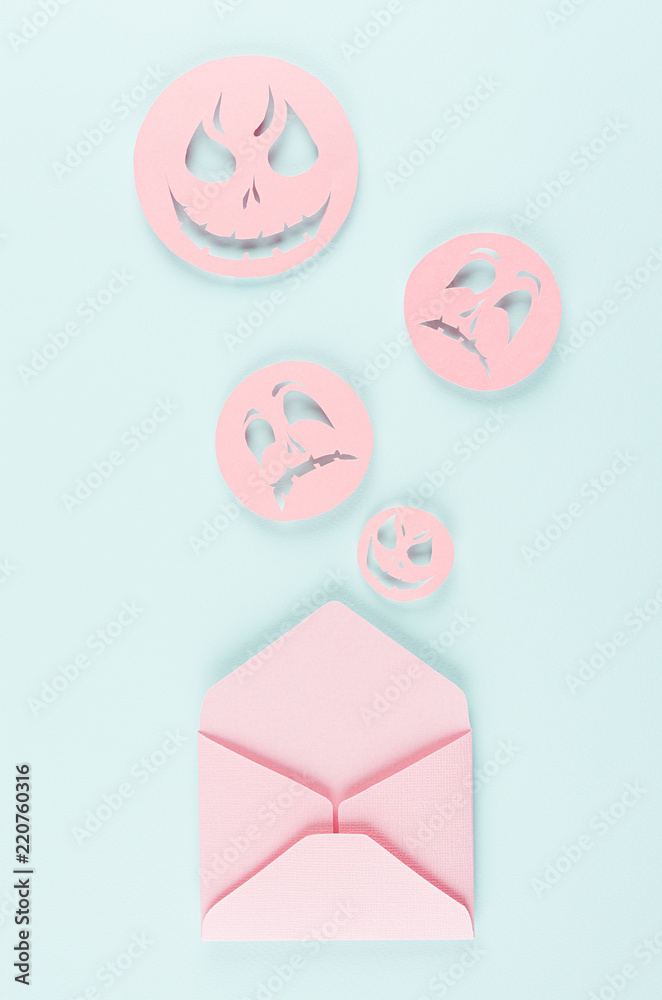 Halloween mock up with open envelope and spooky faces emoji as message of cut paper on pastel trendy mint background. Halloween mock up with open envelope and spooky faces emoji as message of cut paper on pastel trendy mint background.