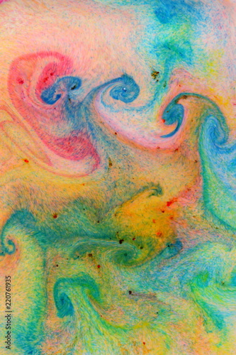 Fluid art. Abstract colorful background. Multicolored stains on liquid. Multicolored pattern with paints on liquid. Blurred background