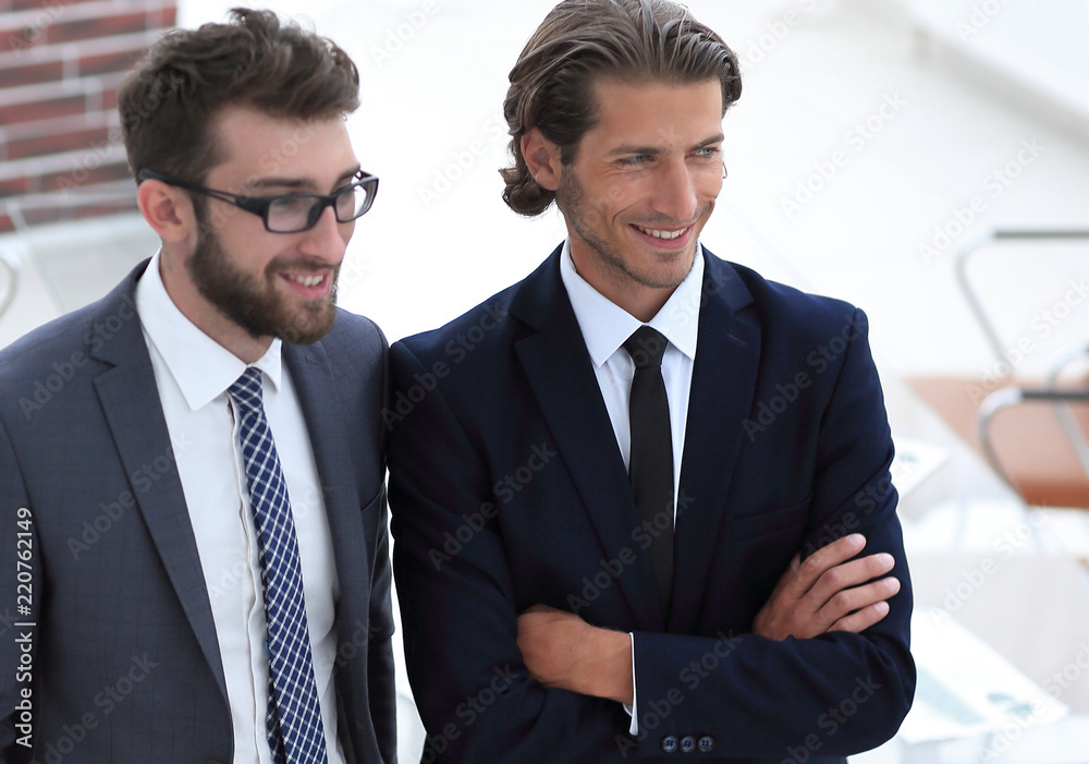 confident businessmen standing together in office confident businessmen standing together in office