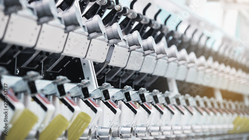 Textile factory. Factory on manufacture of threads. Rows of automated machines for yarn manufacturing. Modern Textile Plant.