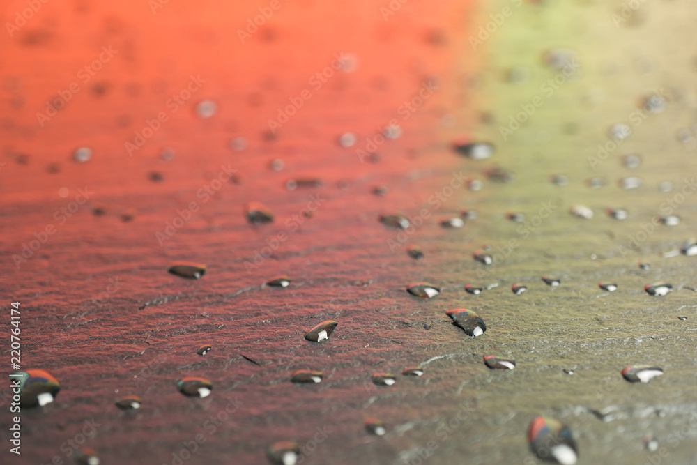 Wet, red glossy asphalt with water drops Wet, red glossy asphalt with water drops