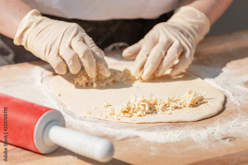 Woman Chef Hands baking dough with rolling pin