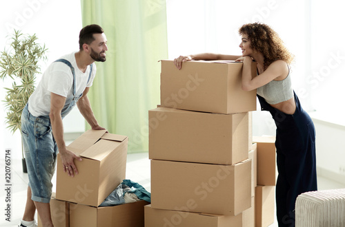 young couple unpacking boxes in a new house