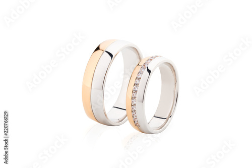 Rose gold and white gold wedding rings isolated on white background
