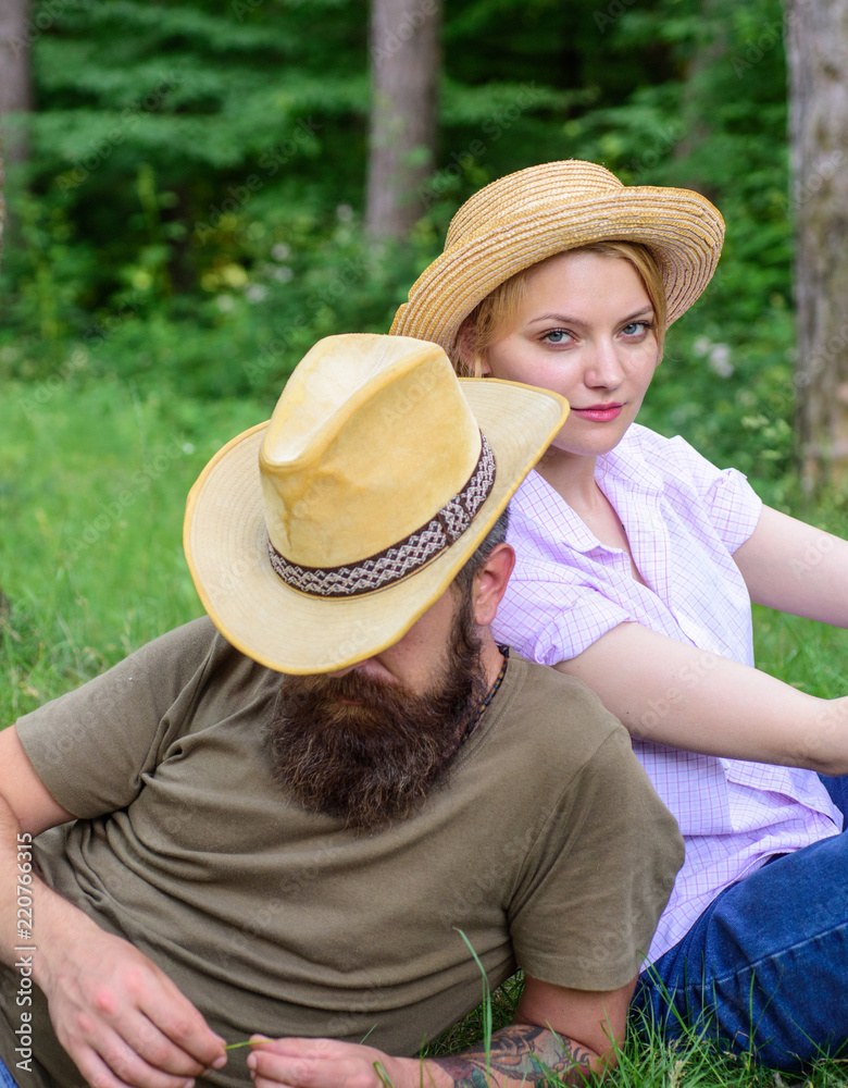 straw hats sit meadow relaxing. Choose 