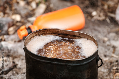 buckwheat cooking in Travel portative gas stove outdoors photo