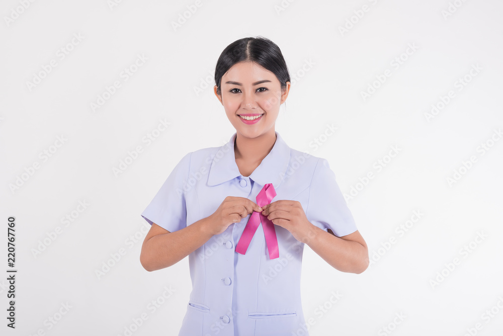 Asian nurse with pink ribbon. Pink ribbon is an international symbol of breast cancer awareness.Medicine and healthcare concept Asian nurse with pink ribbon. Pink ribbon is an international symbol of breast cancer awareness.Medicine and healthcare concept
