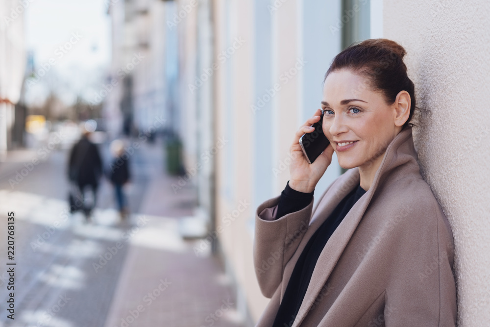 Beautiful woman talking on mobile phone outdoors Beautiful woman talking on mobile phone outdoors