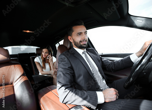 Attractive elegant serious man drives good car photo