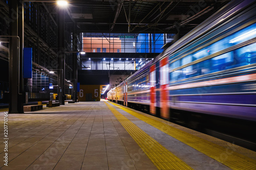 The train departs from the platform at the station, an electric train in motion