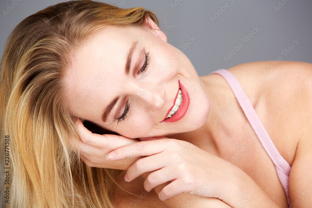 Fototapeta premium Close up happy young blond woman with eyes closed