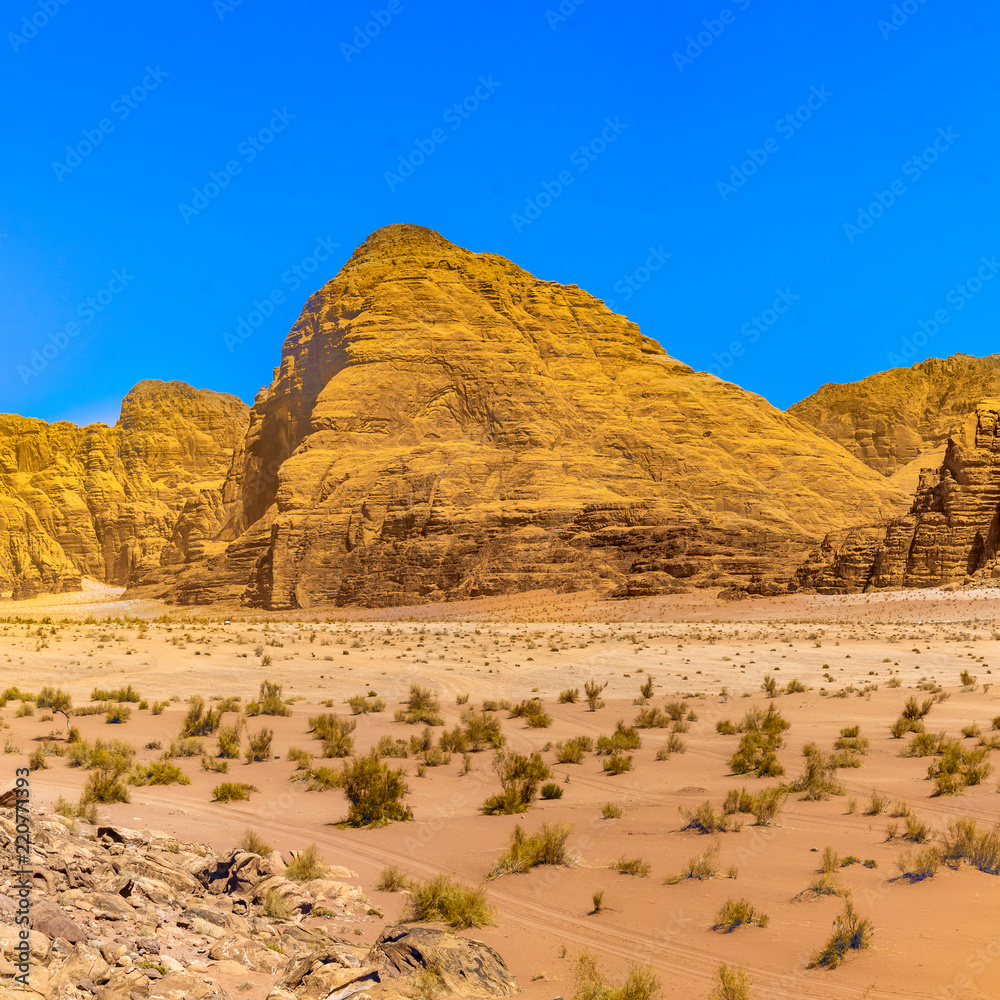 Aerial photo of a monolithic mountain in the central area of the desert reserve of Wadi Rum, Jordan. Aerial photo of a monolithic mountain in the central area of the desert reserve of Wadi Rum, Jordan.