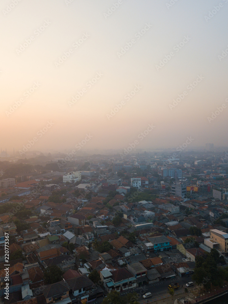 Naklejka premium Hazy morning sky over residential complex in Tangerang, Indonesia.