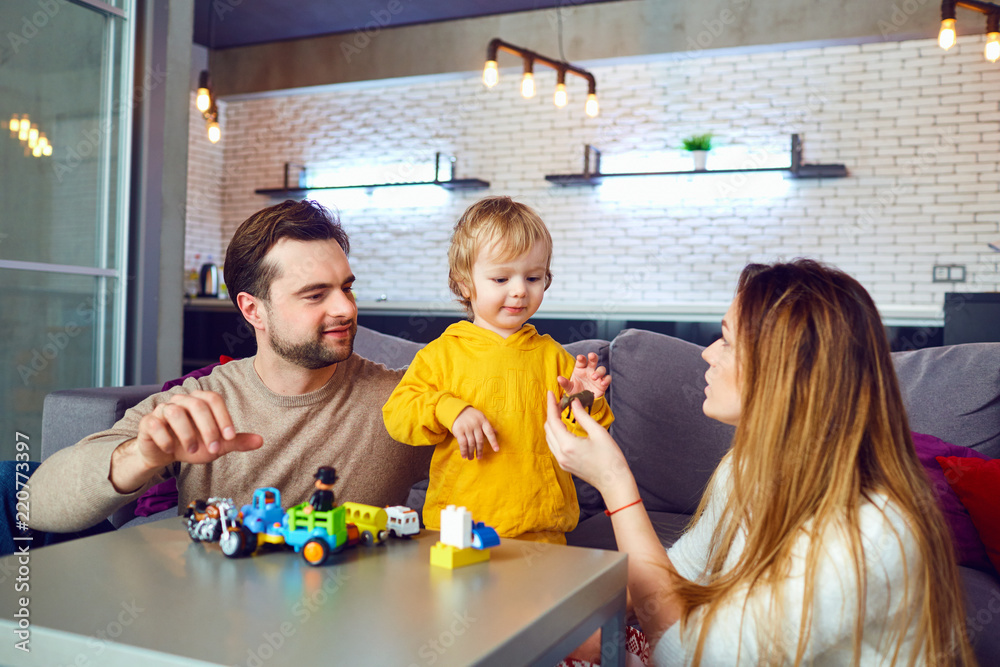 custom made wallpaper toronto digitalMother, father and son play developing games indoors. A happy family is playing at the table in the room.