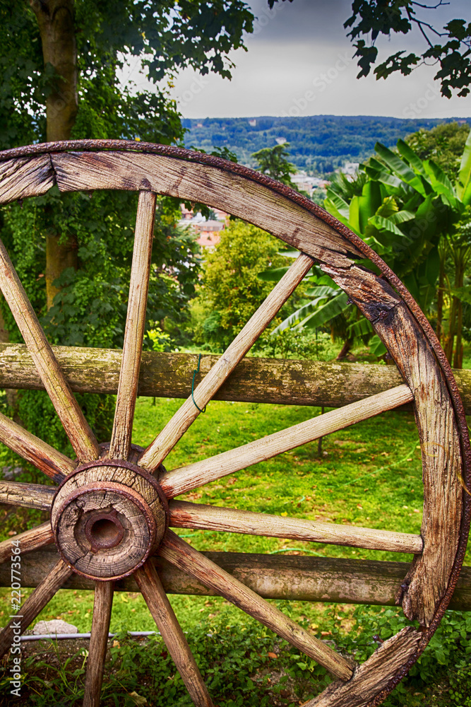 Wooden wheel over wood background Wooden wheel over wood background