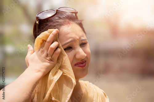 Photography Woman suffers from heat of strong sunlight,Blur background