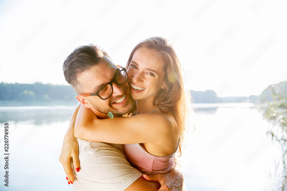 wonderful young couple hug and enjoy life together with natural outdoor laisure activity lifestyle during the summer and the sunset in backlight. wonderful young couple hug and enjoy life together with natural outdoor laisure activity lifestyle during the summer and the sunset in backlight.