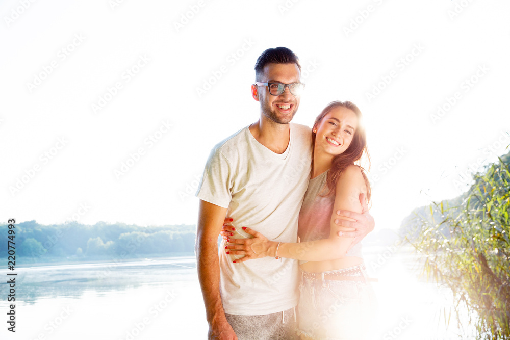 wonderful young couple hug and enjoy life together with natural outdoor laisure activity lifestyle during the summer and the sunset in backlight. wonderful young couple hug and enjoy life together with natural outdoor laisure activity lifestyle during the summer and the sunset in backlight.