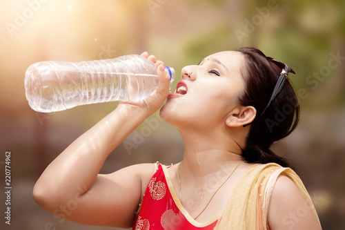 Photography Young woman drinking water.