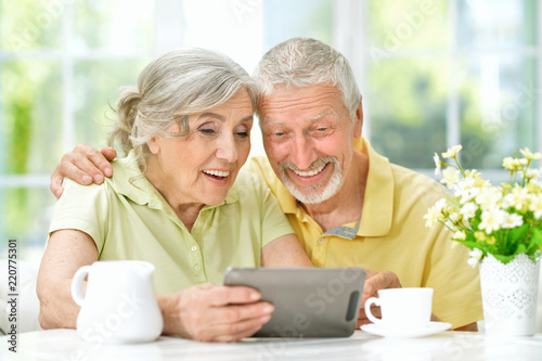 Portrait of a beautiful senior couple using tablet