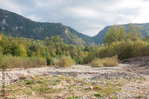 Bright autumn day on the forest river. Kurdzhips river in the Krasnodar region. photo