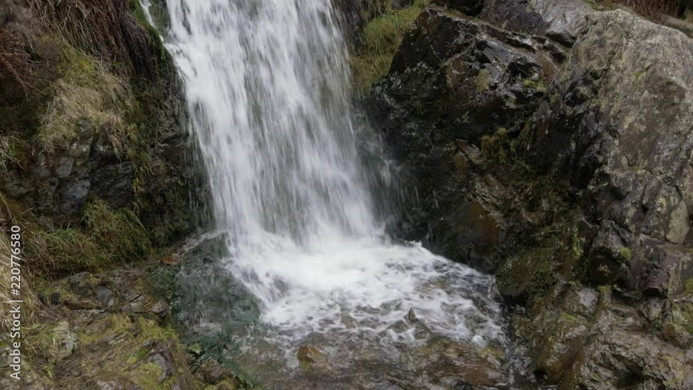 Water pouring over rocks at Lightspout waterfall by Carding Mill Valley in the Shropshire hills Area of Outstanding Natural Beauty, England Water pouring over rocks at Lightspout waterfall by Carding Mill Valley in the Shropshire hills Area of Outstanding Natural Beauty, England