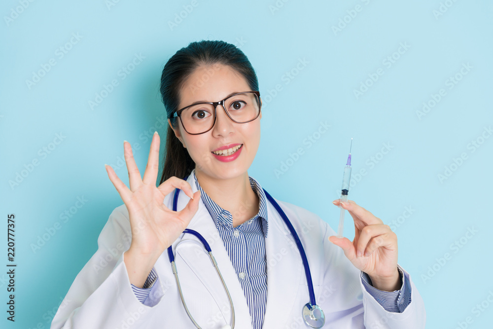 showing an okay sign and an injection. showing an okay sign and an injection.