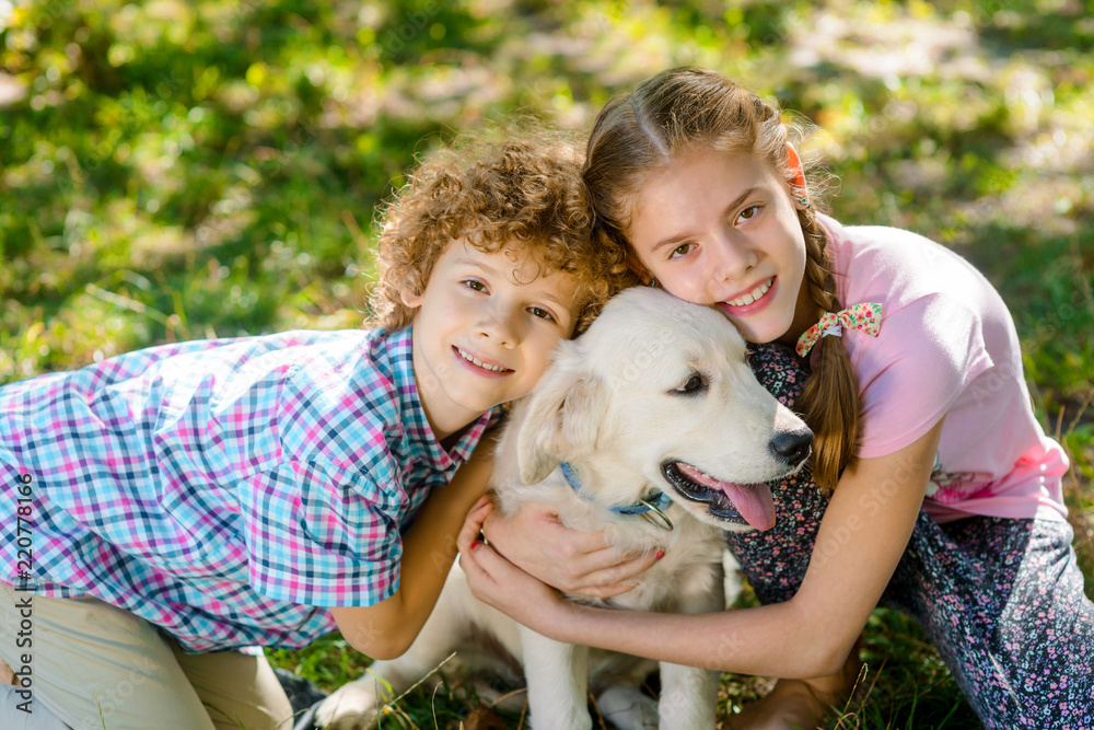 Fototapeta premium Two children with their pet