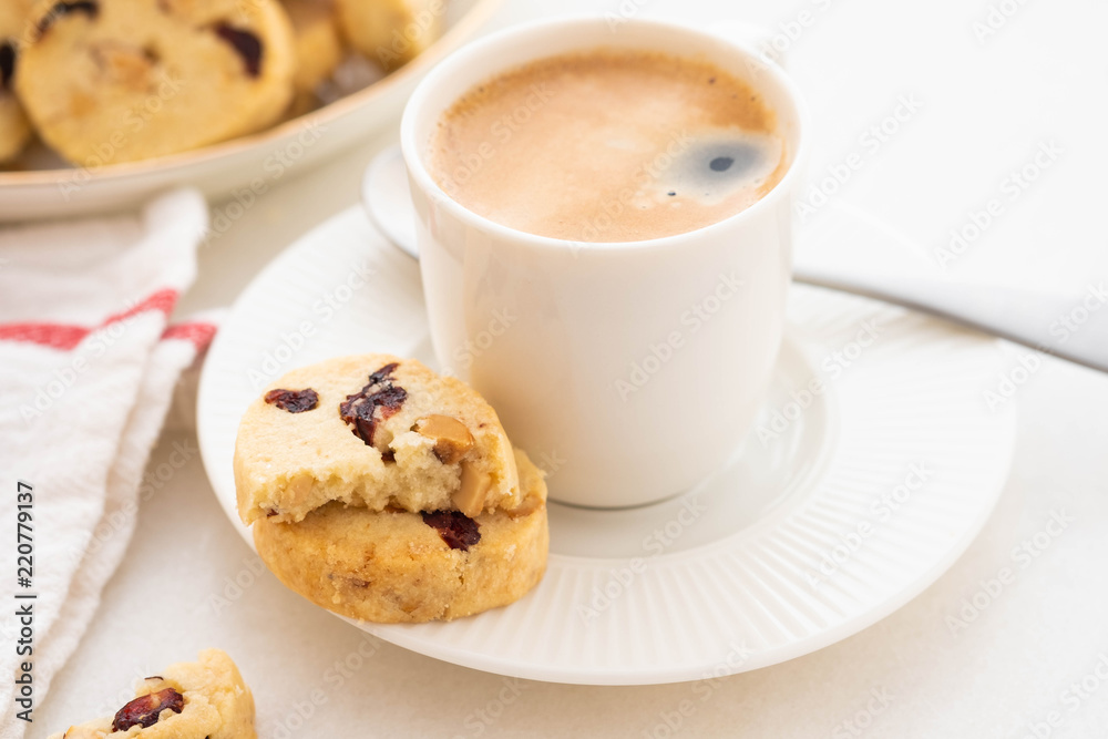 A cup of coffee with homemade cookies on a white background. A cup of coffee with homemade cookies on a white background.