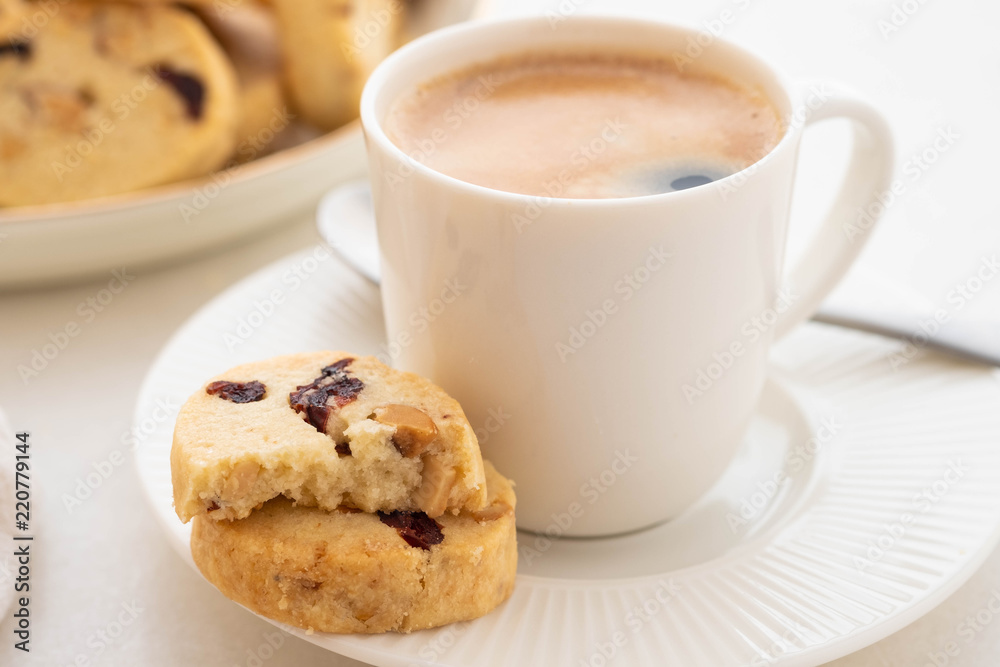 A cup of coffee with homemade cookies on a white background. A cup of coffee with homemade cookies on a white background.