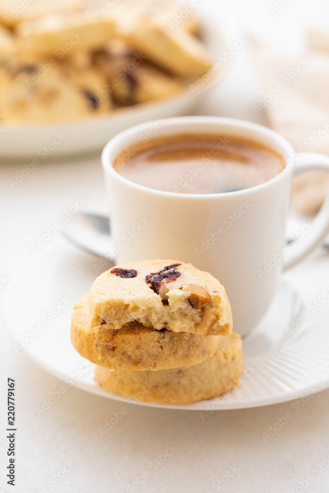 A cup of coffee with homemade cookies on a white background. A cup of coffee with homemade cookies on a white background.