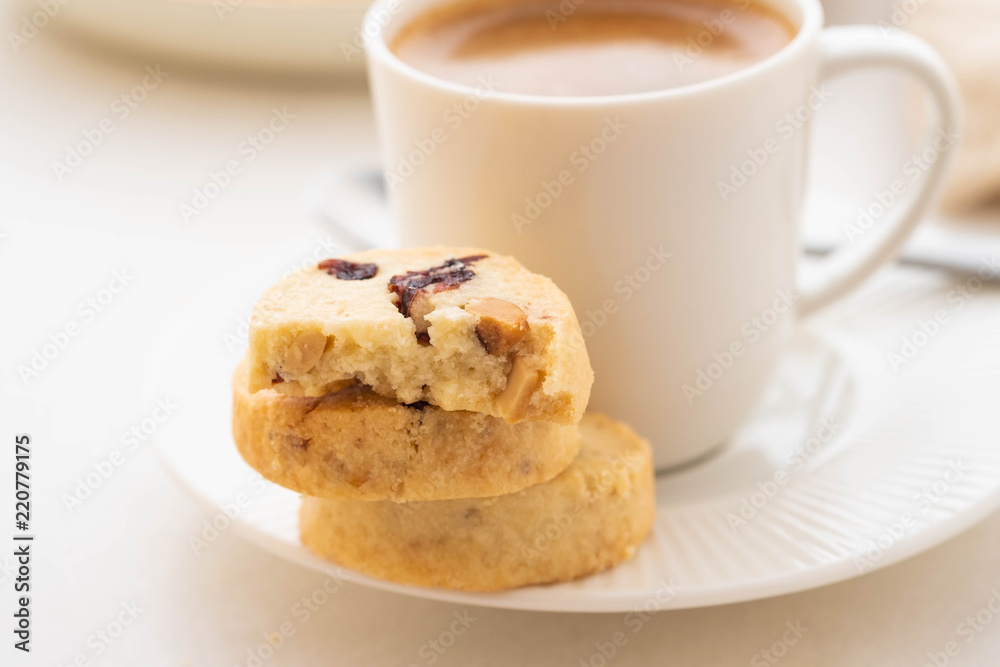 A cup of coffee with homemade cookies on a white background. A cup of coffee with homemade cookies on a white background.