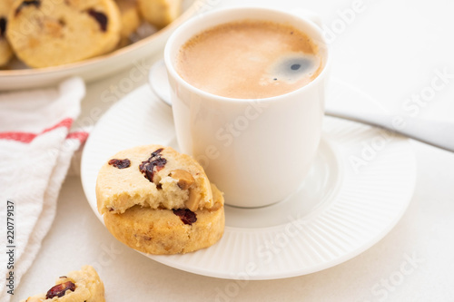 A cup of coffee with homemade cookies on a white background.