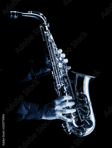 musician playing alt saxophone on black blue image