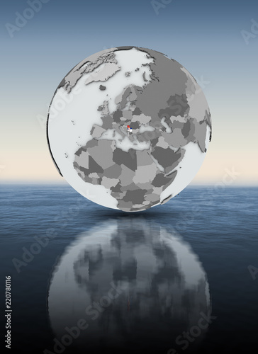Serbia on globe above water