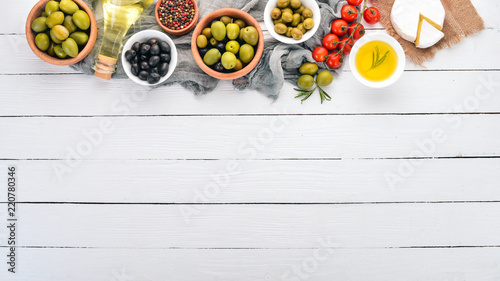 Wallpaper Mural Green olives and black olives, oil, bread, cheese and snacks. Italian cuisine. On a white wooden table. Top view. Free space for text. Torontodigital.ca