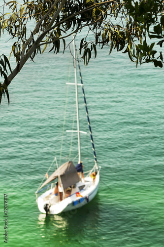 sailboat in beach with happy family at sunset , boat unfocused