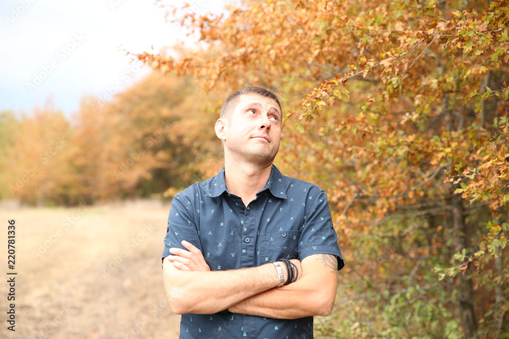 Smiling young handsome happy man outdoors in autumn Smiling young handsome happy man outdoors in autumn