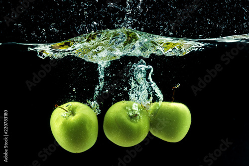 Green apple under water