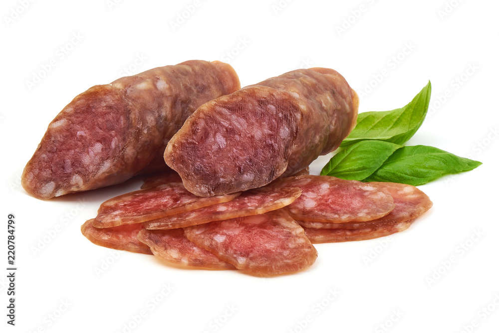 Smoked sausage with thin slices and green basil leaves, isolated on white background