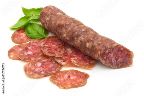 Smoked sausage with slices and green basil leaves, isolated on white background