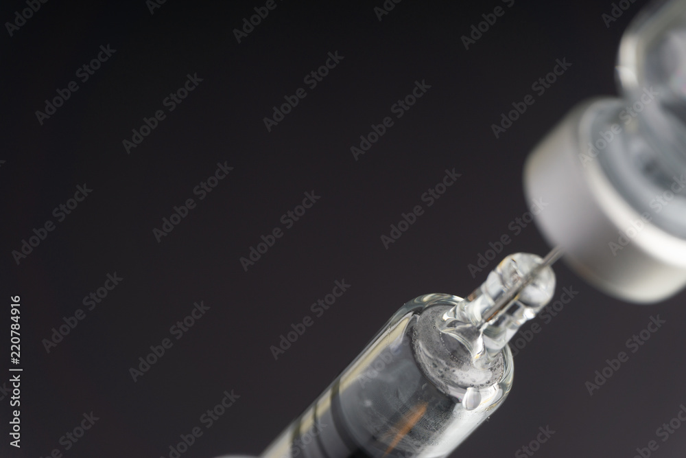 Syringe and vials closeup with selective focus and crop fragment. Medical and Healthcare Concept Syringe and vials closeup with selective focus and crop fragment. Medical and Healthcare Concept