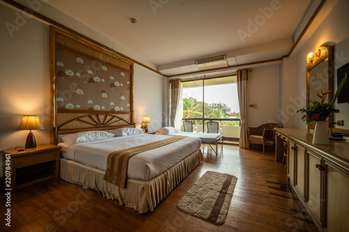 interia perspective of double hotel bedroom with one double bed and on extra bed for three persons at Samed Cabana Samed island Rayong district Thailand