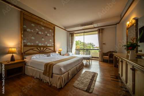 interia perspective of double hotel bedroom with one double bed and on extra bed for three persons at Samed Cabana Samed island Rayong district Thailand photo